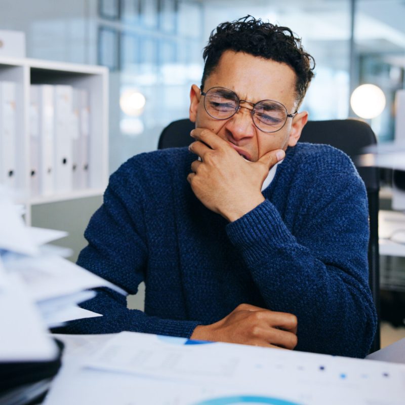Business man, tired and documents in office for project deadline, brain fog and frustrated with ove.